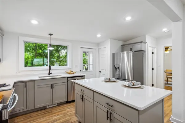 a kitchen with a sink and large window