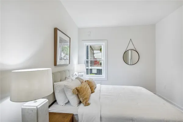 a bedroom with a bed and a window