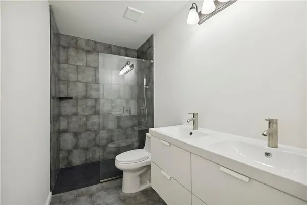 a bathroom with a sink mirror and toilet
