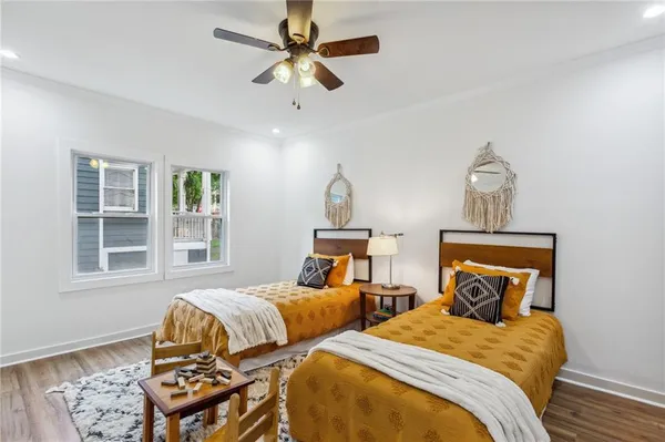 a bedroom with two beds and a window