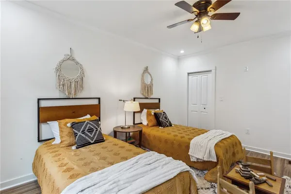 a bedroom with two beds and a chandelier