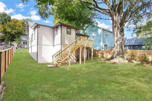 a view of a house with a small deck