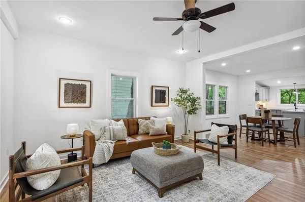 a living room with furniture and a dining table