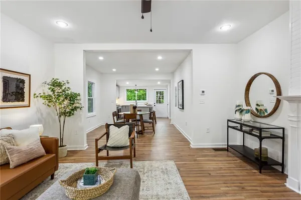 a living room with furniture and a potted plant