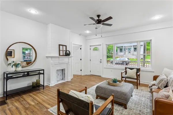 a living room with fireplace furniture and a window