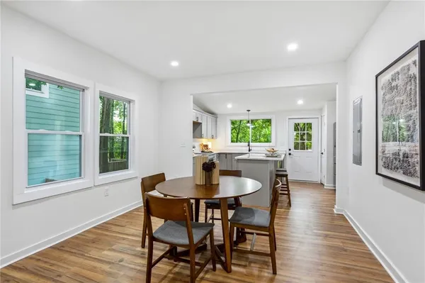 a dining room with furniture and wooden floor