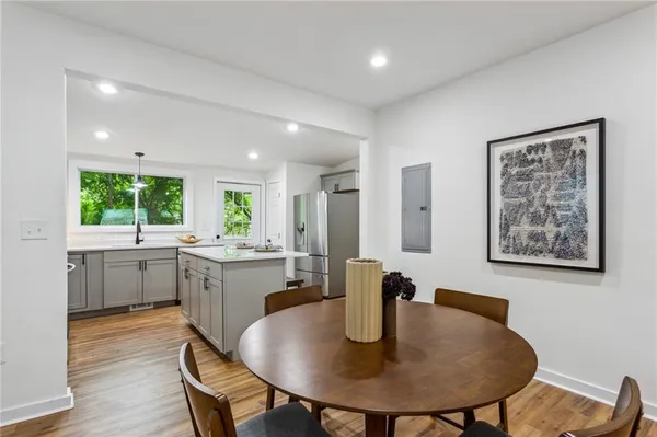 a kitchen with a table chairs sink and couch