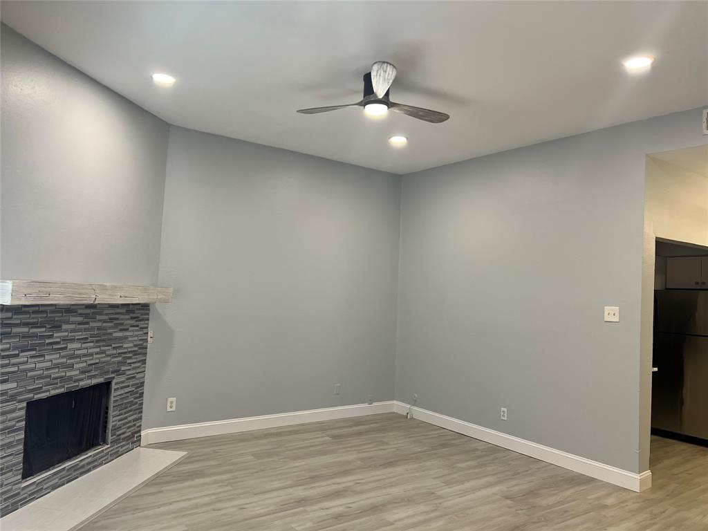 3121 Rosedale Avenue University Park, TX 75205 - Photo 5 of 16 Living area featuring a fireplace with a textured tile surround and a wood mantel. This modern look is what is planned for the renovations.