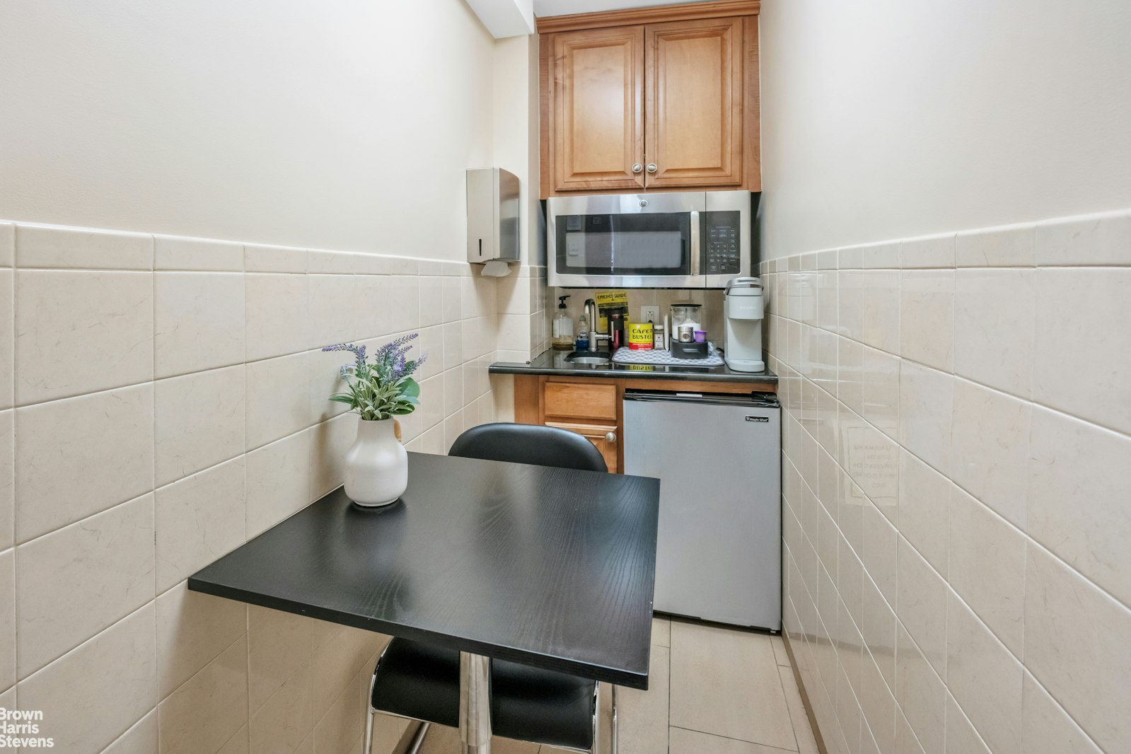 235 East 22nd Street, Unit 1EF Manhattan, NY 10010 - Photo 11 of 15 a kitchen with a sink a microwave and cabinets