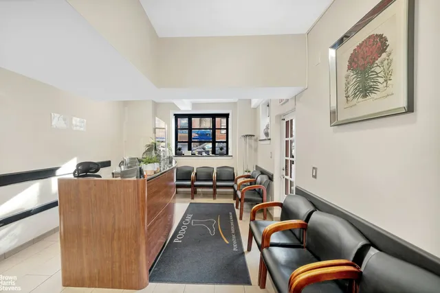a living room with furniture and a book shelf