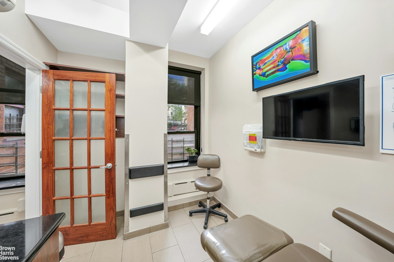 235 East 22nd Street, Unit 1EF Manhattan, NY 10010 - Photo 8 of 15 a living room with furniture and a flat screen tv