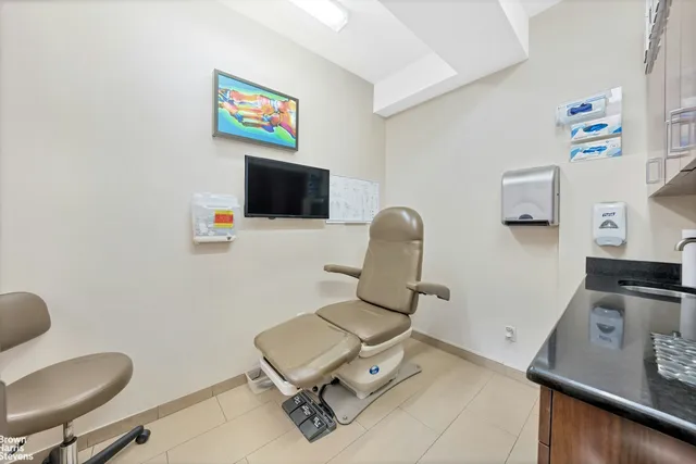 a work room with furniture and a flat screen tv