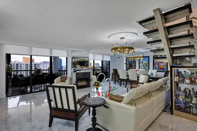 a dining room with furniture a chandelier and wooden floor