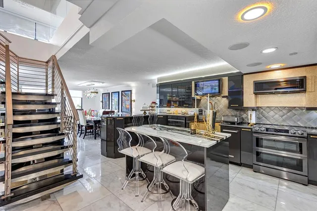 a bedroom with a large bed and a flat tv screen on dresser