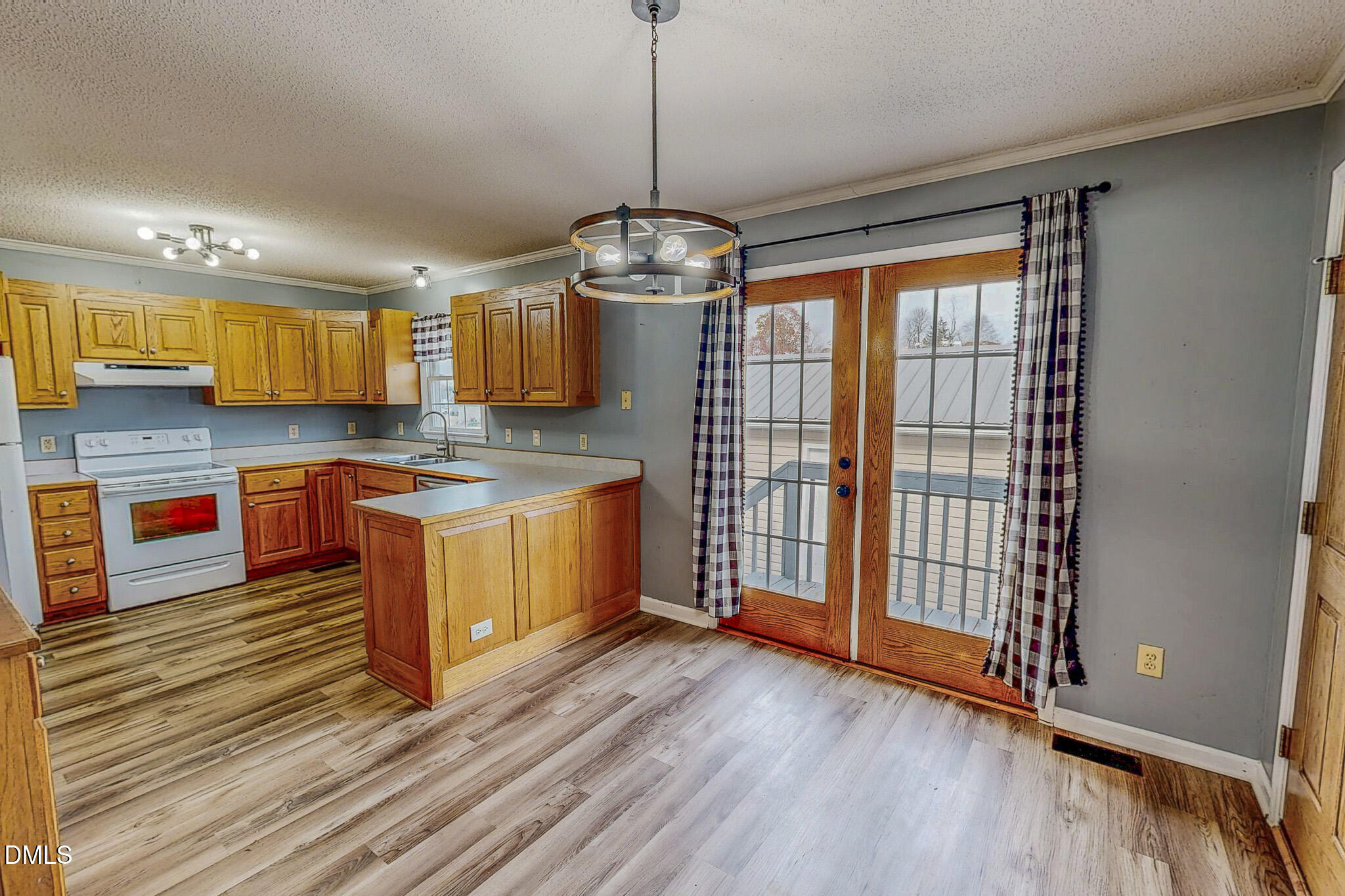 111 Fox Crossing Drive Roxboro, NC 27574 - Photo 4 of 25 a kitchen with stainless steel appliances granite countertop a stove a sink and a wooden floors