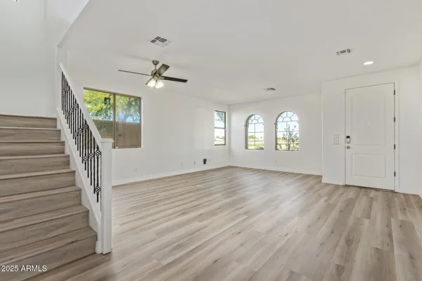 a view of entryway and hall with wooden floor