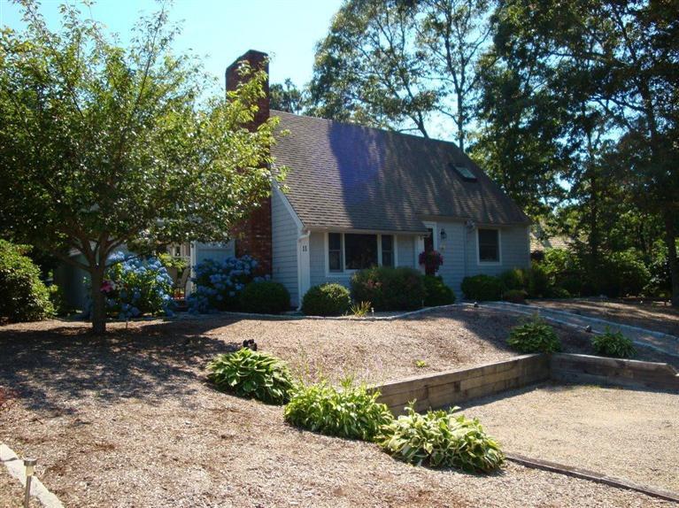 11 Summersea Road Mashpee, MA 02649 - Photo 1 of 12 a front view of a house with a yard and a tree