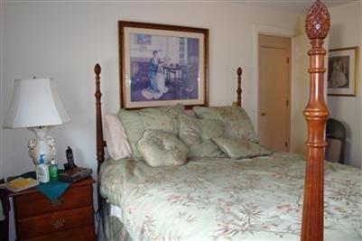 11 Summersea Road Mashpee, MA 02649 - Photo 6 of 12 a bed sitting in a room next to a lamp