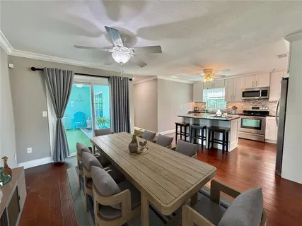 a kitchen with granite countertop a stove a sink and a microwave
