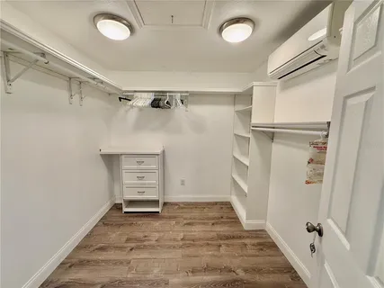 a spacious bedroom with a bed and a chandelier
