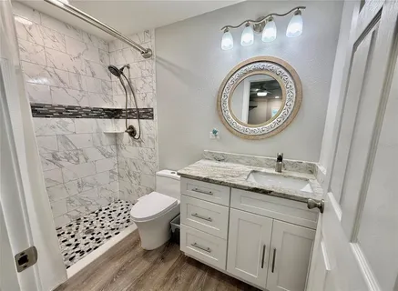 a bedroom with a bed and a night stand