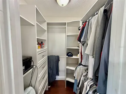 a view of a chairs and table in patio next to a yard