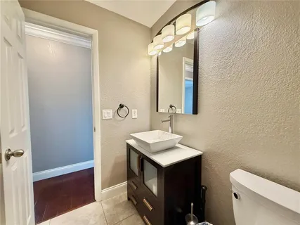 an aerial view of a tennis ground and a cars park