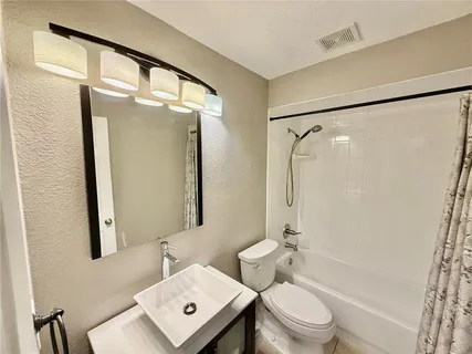 a view of a chairs and table in a backyard