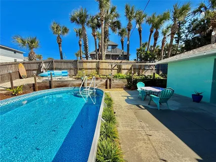 an aerial view of residential houses with outdoor space and street view