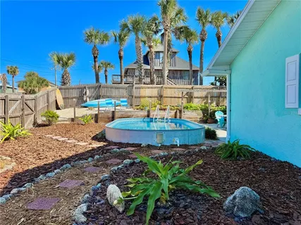 an aerial view of multiple houses with yard