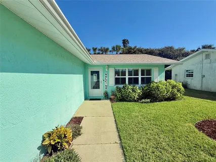 a view of a dining room with furniture and window