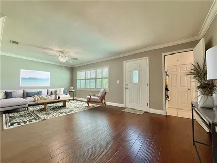 a dining room with furniture window and wooden floor