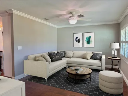 a kitchen with stainless steel appliances granite countertop a dining table chairs refrigerator and microwave