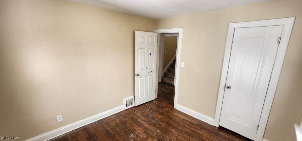 3599 Grosvenor Road Cleveland, OH 44118 - Photo 15 of 25 Unfurnished bedroom featuring baseboards and dark wood-style floors