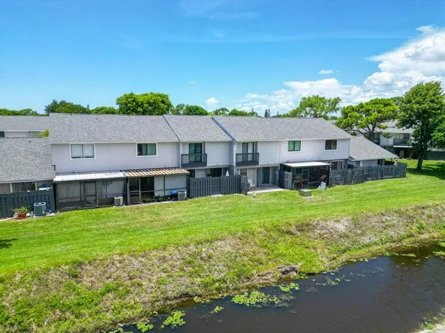 a aerial view of a house with a yard table and chairs
