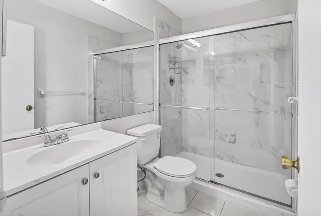 a bathroom with a sink mirror toilet and shower