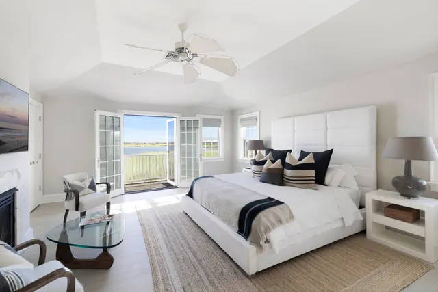 a large bedroom with a bed and large windows