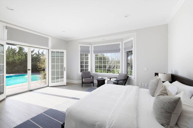 a bedroom with a bed and glass window