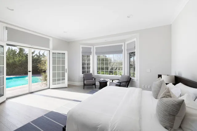 a bedroom with a bed and glass window