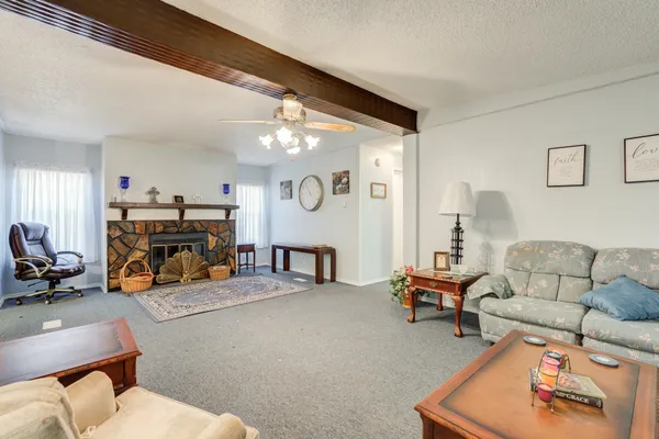 a living room with furniture and a dining table with kitchen view