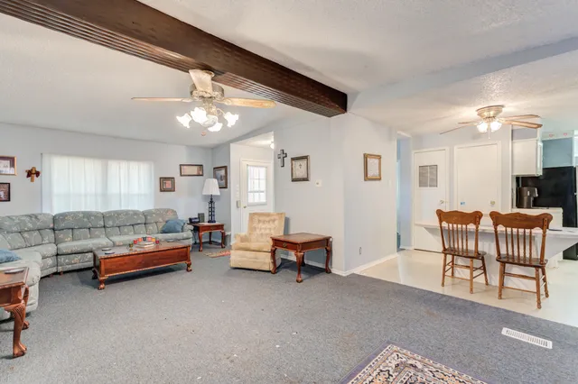 a living room with furniture and a chandelier