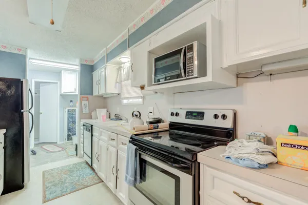 a kitchen with a sink cabinets and a stove