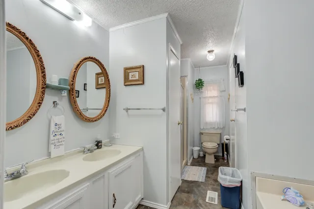 a bedroom with bed and wooden floor