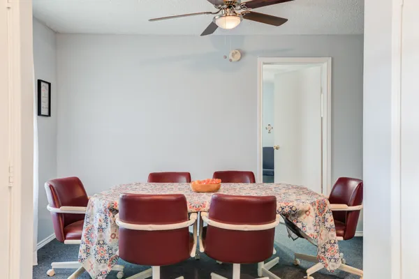 a room with furniture and fan