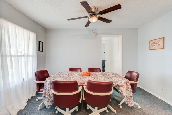 a dining room with furniture and window