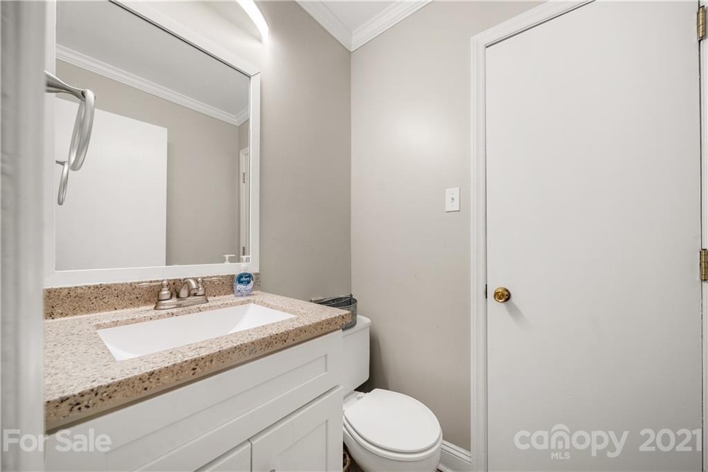 2508 Milton Road Charlotte, NC 28215 - Photo 13 of 17 a bathroom with a granite countertop sink a toilet and shower