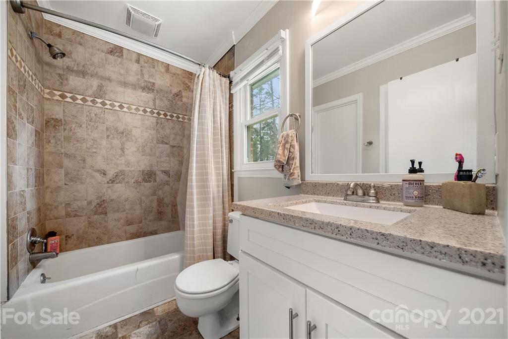 2508 Milton Road Charlotte, NC 28215 - Photo 10 of 17 a bathroom with a granite countertop sink toilet mirror and bathtub