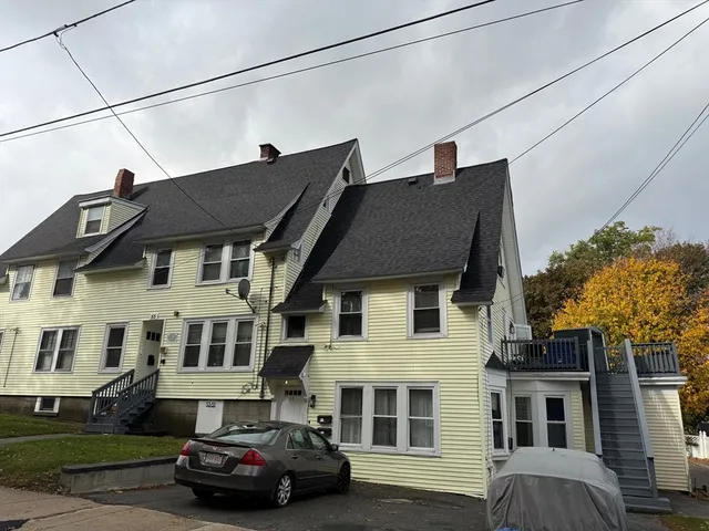 a car parked in front of a white building