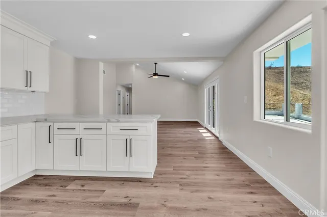 a view of a kitchen with granite countertop cabinets and a wooden floor