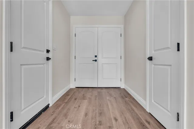 a view of a hallway with wooden floor